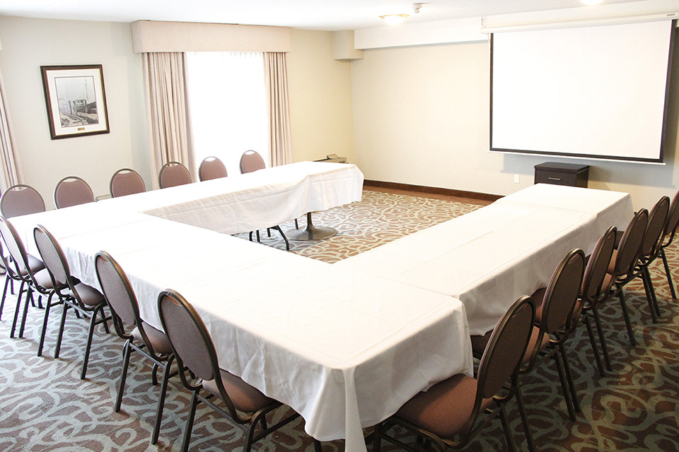 Conference room with U table and a presentation board