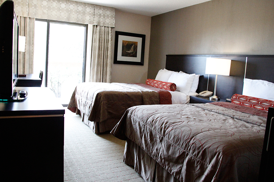 Bedroom with two queen beds and a television